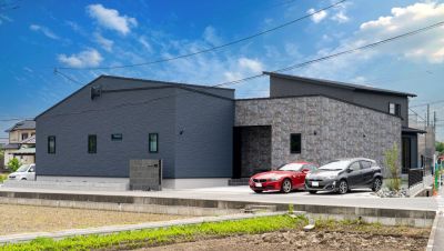 石調とモノトーンを組み合わせた、重厚感ある二世帯住宅